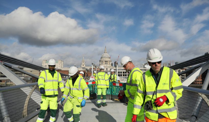 LONDON, ENGLAND - OCTOBER 24: Construction workers stand on London's Millennium Bridge on October 24, 2023 in London, United Kingdom. London's 'Wobbly Bridge' is undergoing a temporary three-week closure from October 14 to November 5 for critical repairs, with a primary focus on replacing the deteriorated separation layer beneath its aluminium deck, addressing years of wear and tear. (Photo by Alishia Abodunde/Getty Images)