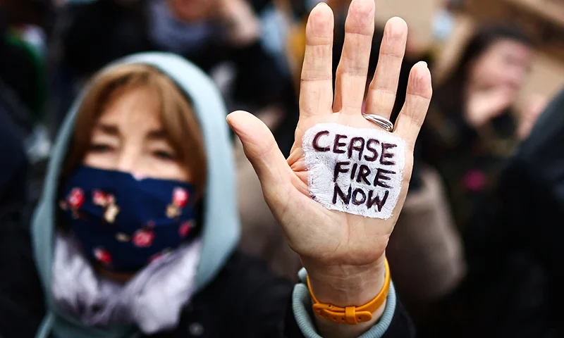 A Pro-Palestinian supporter shows their hand reading "Cease fire now" during a demonstration in central London on January 6, 2024, calling for a ceasefire now in the war in Gaza. Thousands of civilians, both Palestinians and Israelis, have died since October 7, 2023, after Palestinian Hamas militants based in the Gaza Strip entered southern Israel in an unprecedented attack triggering a war declared by Israel on Hamas with retaliatory bombings on Gaza. (Photo by HENRY NICHOLLS / AFP) (Photo by HENRY NICHOLLS/AFP via Getty Images)