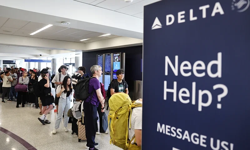 Travelers wait in line on the check-in floor of the Delta Air Lines terminal at Los Angeles International Airport (LAX) on July 23, 2024 in Los Angeles, California. Delta Air Lines is still reeling in the aftermath of the CrowdStrike outage with 24 flights cancelled and 27 flights delayed at LAX today and 434 cancelled Delta flights nationwide today. (Photo by Mario Tama/Getty Images)