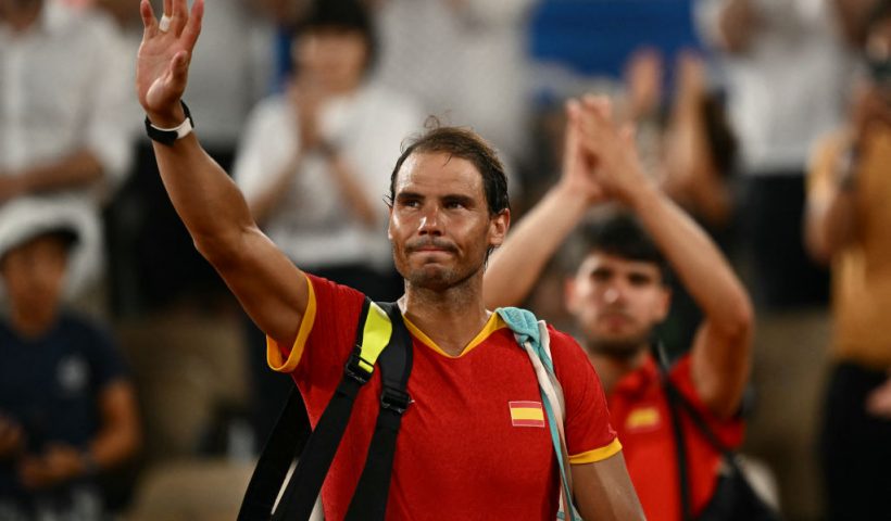 TOPSHOT - Spain's Rafael Nadal waves goodbye after he and Spain's Carlos Alcaraz lose to US' Austin Krajicek and US' Rajeev Ram in their men's doubles quarter-final tennis match on Court Philippe-Chatrier at the Roland-Garros Stadium during the Paris 2024 Olympic Games, in Paris on July 31, 2024. (Photo by CARL DE SOUZA / AFP) (Photo by CARL DE SOUZA/AFP via Getty Images)