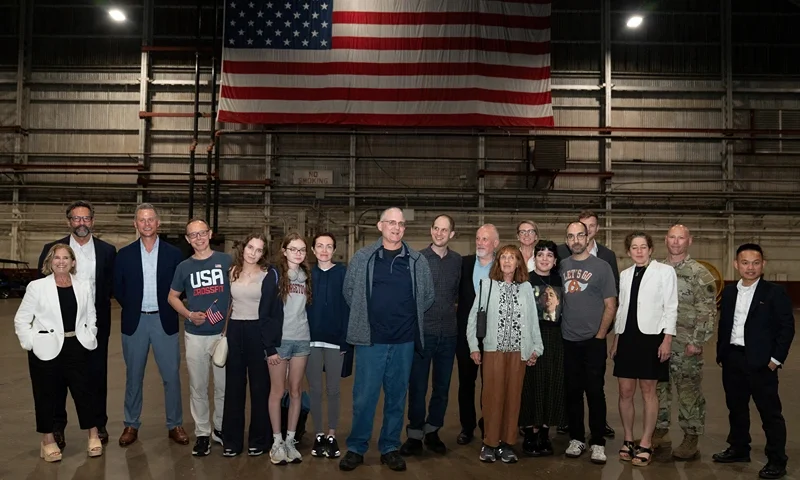 Former prisoners released by Russia, Evan Gershkovich (C), former US marine Paul Whelan (9thL), and journalist US-Russian Alsu Kurmasheva (7thL) pose after landing at Joint Base San Antonio-Kelly Field, Texas, on August 2, 2024. Journalist Evan Gershkovich and fellow prisoners released by Russia landed in the United States late August 1, as part of an extraordinary swap deal struck between Washington and Moscow. A plane carrying Gershkovich, former US marine Paul Whelan, and journalist Alsu Kurmasheva landed at around 11:40 pm (0340 GMT) at Joint Base Andrews near Washington, where President Joe Biden and Vice President Kamala Harris were waiting to greet them. (Photo by SUZANNE CORDEIRO / AFP) (Photo by SUZANNE CORDEIRO/AFP via Getty Images)