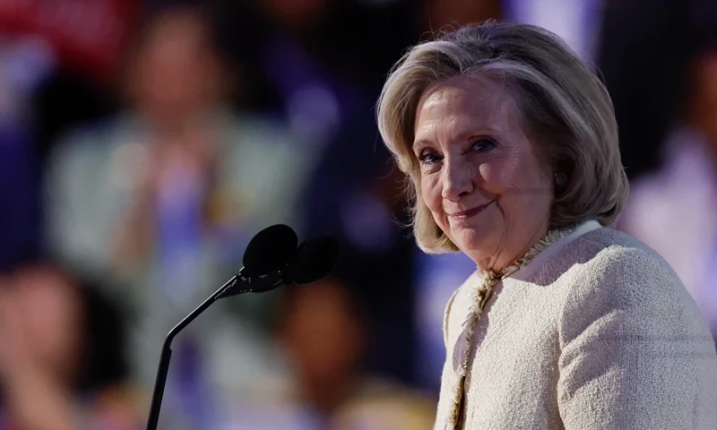 Former US Secretary of State Hillary Clinton looks on as she is applauded after arriving on stage to speak on the first day of the Democratic National Convention (DNC) at the United Center in Chicago, Illinois, on August 19, 2024. Vice President Kamala Harris will formally accept the party's nomination for president at the DNC which runs from August 19-22 in Chicago. (Photo by KAMIL KRZACZYNSKI / AFP) (Photo by KAMIL KRZACZYNSKI/AFP via Getty Images)