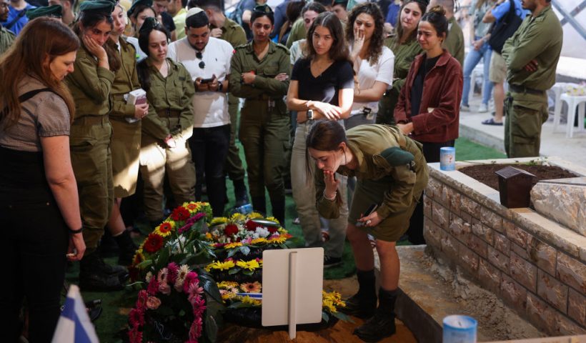Relatives and friends mourn by the grave of Israeli soldier Eitan Itzhak Oster killed in fighting in the northern border area with Lebanon, during his funeral at the Mount Herzl Military Cemetery in Jerusalem on October 2, 2024. Confirmation of the fighting in two areas of the border came hours after Iran launched its second-ever direct attack on Israel, with the Israeli army announcing that eight soldiers have been killed so far in combat in southern Lebanon. (Photo by Ahmad GHARABLI / AFP) (Photo by AHMAD GHARABLI/AFP via Getty Images)