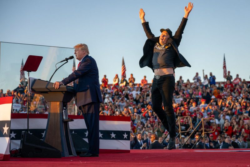 TOPSHOT - Tesla CEO Elon Musk (R) jumps on stage as he joins former US President and Republican presidential candidate Donald Trump during a campaign rally at site of his first assassination attempt in Butler, Pennsylvania on October 5, 2024. (Photo by Jim WATSON / AFP) (Photo by JIM WATSON/AFP via Getty Images)