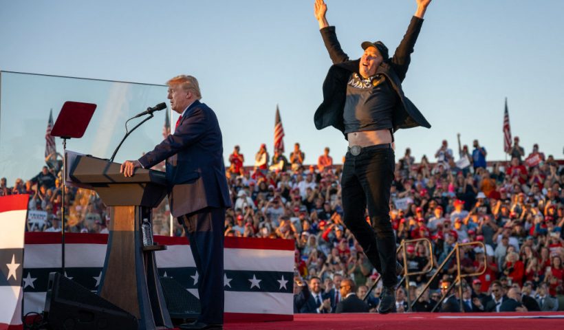 TOPSHOT - Tesla CEO Elon Musk (R) jumps on stage as he joins former US President and Republican presidential candidate Donald Trump during a campaign rally at site of his first assassination attempt in Butler, Pennsylvania on October 5, 2024. (Photo by Jim WATSON / AFP) (Photo by JIM WATSON/AFP via Getty Images)