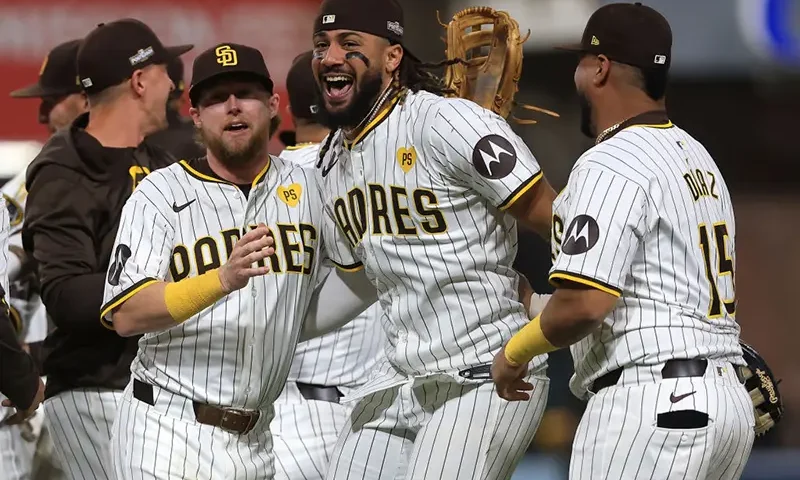 Jake Cronenworth #9, Fernando Tatis Jr. #23 and Elias Díaz #15 of the San Diego Padres celebrate after defeating the Atlanta Braves in Game Two to win the Wild Card Series at Petco Park on October 02, 2024 in San Diego, California. (Photo by Sean M. Haffey/Getty Images)