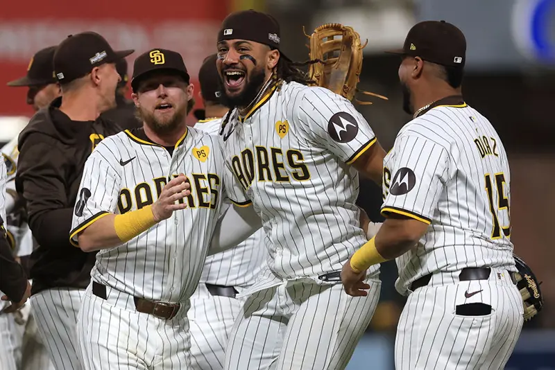 Jake Cronenworth #9, Fernando Tatis Jr. #23 and Elias Díaz #15 of the San Diego Padres celebrate after defeating the Atlanta Braves in Game Two to win the Wild Card Series at Petco Park on October 02, 2024 in San Diego, California. (Photo by Sean M. Haffey/Getty Images)