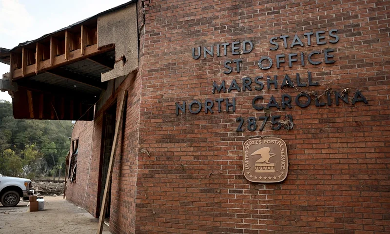 A view of a United States Post Office, damaged by flooding from Hurricane Helene, on October 3, 2024 in Marshall, North Carolina. State election officials will face a challenge ensuring voting access to those who will vote by mail in the November presidential elections following widespread flooding in Western North Carolina. At least 200 people were killed in six states in the wake of the powerful hurricane which made landfall as a Category 4. President Joe Biden took an aerial tour of the devastated region yesterday and ordered the deployment of 1,000 active duty U.S. soldiers to assist with storm relief efforts and reinforce the North Carolina National Guard. (Photo by Mario Tama/Getty Images)