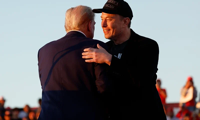 Elon Musk embraces Republican presidential nominee, former President Donald Trump during a campaign rally at the Butler Farm Show fairgrounds on October 05, 2024 in Butler, Pennsylvania. This is the first time that Trump has returned to Butler since he was injured during an attempted assassination on July 13. (Photo by Anna Moneymaker/Getty Images)