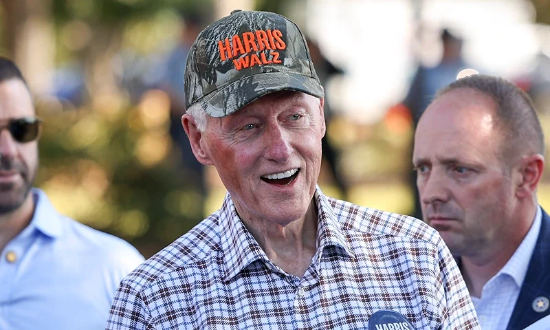 Former US President Bill Clinton arrives for a "Get Out the Vote" Community Fish Fry at the Agricultural Technology Conference Center as he campaigns for Vice President Kamala Harris in Fort Valley, Georgia, on October 13, 2024. The former president is stumping for Vice President Harris days before early voting starts in Georgia. (Photo by Logan Cyrus / AFP) (Photo by LOGAN CYRUS/AFP via Getty Images)