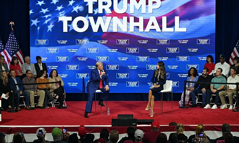 Former US President and Republican presidential candidate Donald Trump, with moderator and South Dakota Governor Kristi Noem (C R), speaks during a town hall at the Greater Philadelphia Expo Center and Fairgrounds in Oaks, Pennsylvania, on October 14, 2024. (Photo by Jim WATSON / AFP) (Photo by JIM WATSON/AFP via Getty Images)
