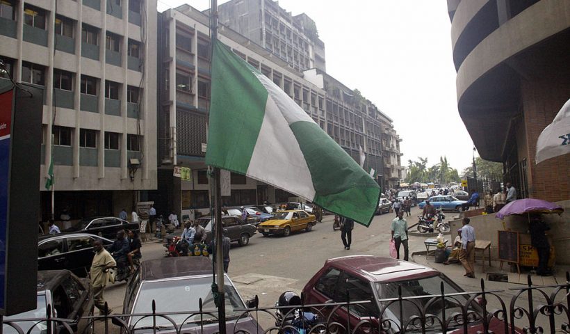 Lagos, NIGERIA: A Nigerian flag flies at half mast at a Lagos public building 24 October 2005. The Nigerian government has declared a three-day national mourning in honour of 117 passengers who died in a Bellview air crash at Lissa village in Ifo district southwest Nigeria. (Photo credit should read PIUS UTOMI EKPEI/AFP via Getty Images)