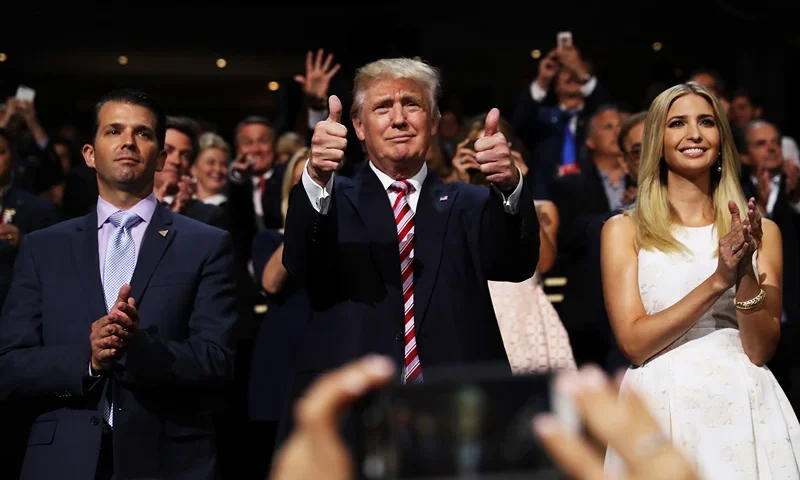 CLEVELAND, OH - JULY 20: Republican presidential candidate Donald Trump (C) gives two thumbs up as Donald Trump Jr. (L) and Ivanka Trump (R) stand and cheer for Eric Trump as he delivers his speech during the third day of the Republican National Convention on July 20, 2016 at the Quicken Loans Arena in Cleveland, Ohio. Republican presidential candidate Donald Trump received the number of votes needed to secure the party's nomination. An estimated 50,000 people are expected in Cleveland, including hundreds of protesters and members of the media. The four-day Republican National Convention kicked off on July 18. (Photo by Joe Raedle/Getty Images)