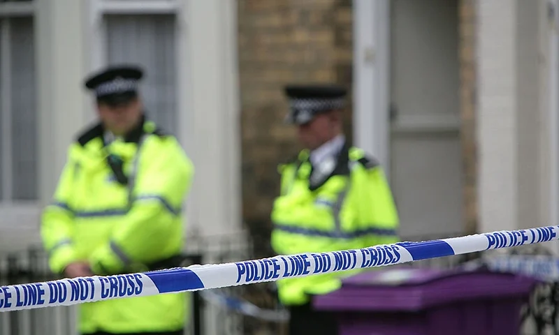 LIVERPOOL, UNITED KINGDOM - JULY 1: Police officers stand outside a house in Hatherley Street, after a raid searching for terror suspects on July 1, 2007 in Liverpool, England. Police launched raids on two properties in Liverpool and Glasgow after making a fifth arrest in connection with the national terrorism alert. (Photo by Christopher Furlong/Getty Images)