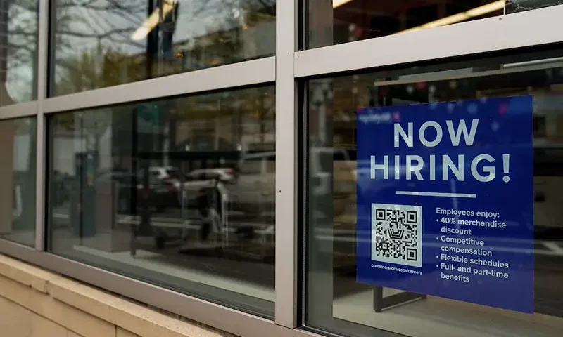 An employee hiring sign with a QR code is seen in a window of a business in Arlington, Virginia, U.S., April 7, 2023. REUTERS/Elizabeth Frantz/File Photo