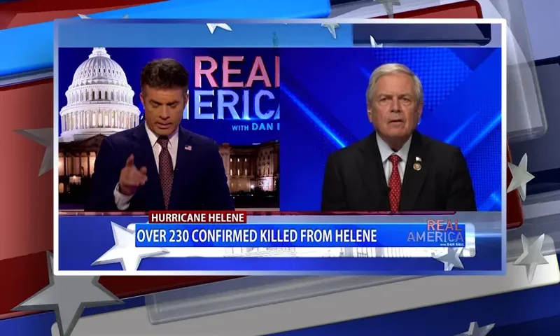 Video still from Real America on One America News Network showing a split screen of the host on the left side, and on the right side is the guest, Ralph Norman.