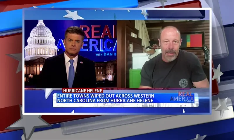 Video still from Real America on One America News Network showing a split screen of the host on the left side, and on the right side is the guest, Tom Teague.