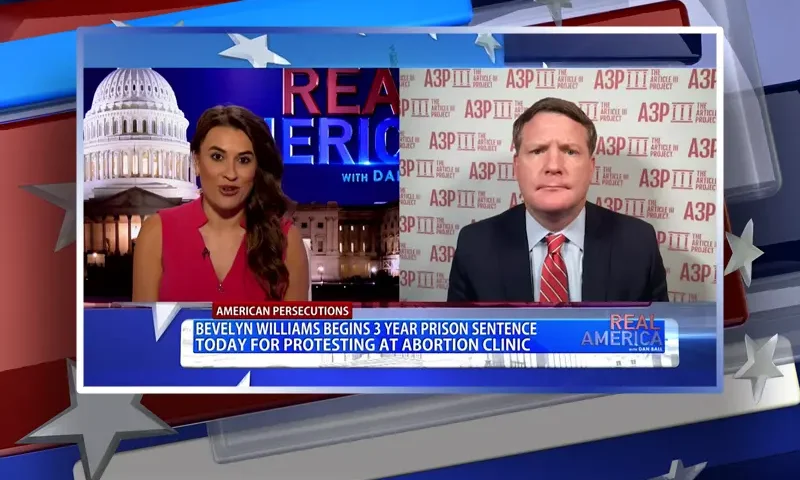 Video still from Real America on One America News Network showing a split screen of the host on the left side, and on the right side is the guest, Mike Davis.