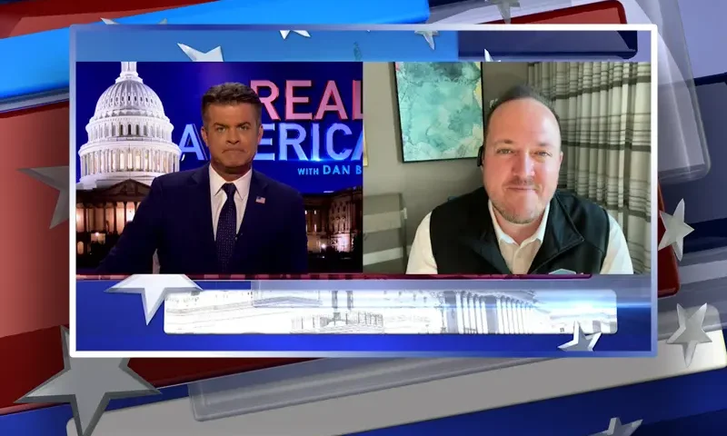 Video still from Real America on One America News Network showing a split screen of the host on the left side, and on the right side is the guest, Cliff Maloney.