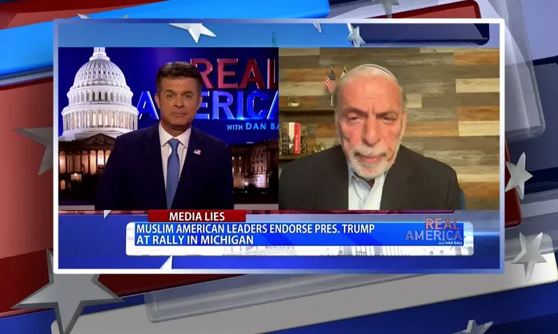 Video still from Real America on One America News Network showing a split screen of the host on the left side, and on the right side is the guest, Dov Hikind.