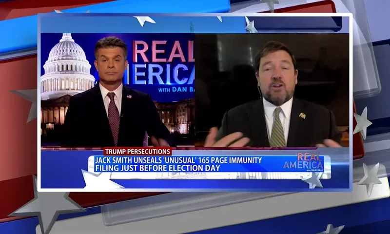 Video still from Real America on One America News Network showing a split screen of the host on the left side, and on the right side is the guest, Ed Martin.