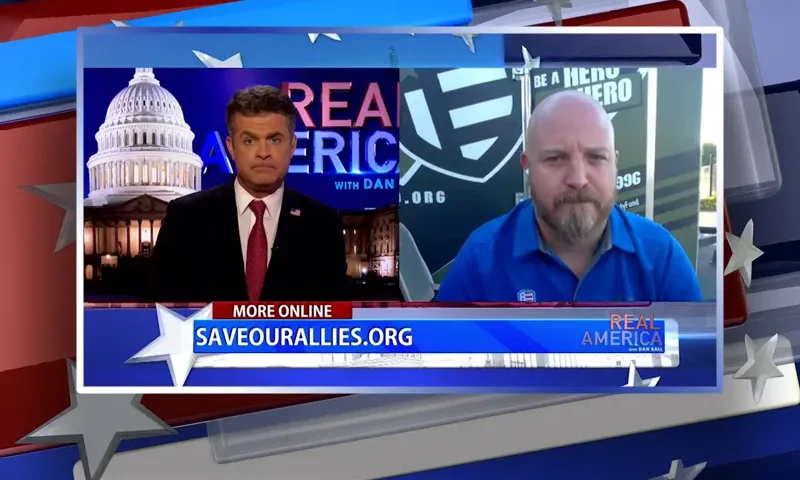 Video still from Real America on One America News Network showing a split screen of the host on the left side, and on the right side is the guest, Steve Rozina.