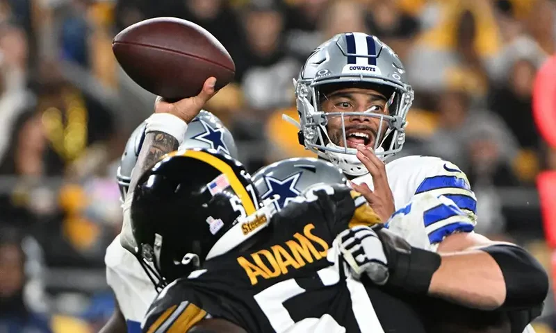Dallas Cowboys quarterback Dak Prescott (4) l throws a pass while being pressured by Pittsburgh Steelers defensive tackle Montravius Adams (57) during the second quarter at Acrisure Stadium. Mandatory Credit: Barry Reeger-Imagn Images