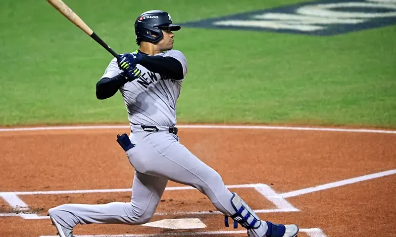 New York Yankees outfielder Juan Soto (22) hits a double during the first inning against the Cleveland Guardians during game five of the ALCS for the 2024 MLB playoffs at Progressive Field. Mandatory Credit: David Richard-Imagn Images