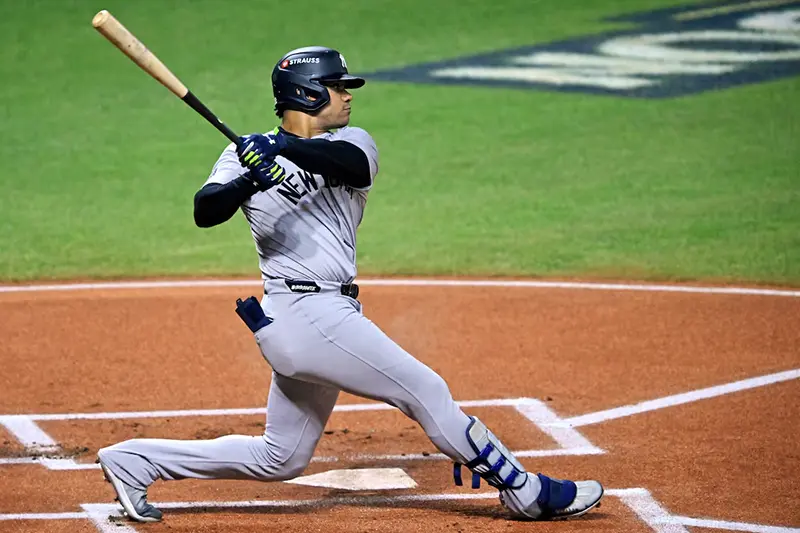 New York Yankees outfielder Juan Soto (22) hits a double during the first inning against the Cleveland Guardians during game five of the ALCS for the 2024 MLB playoffs at Progressive Field. Mandatory Credit: David Richard-Imagn Images