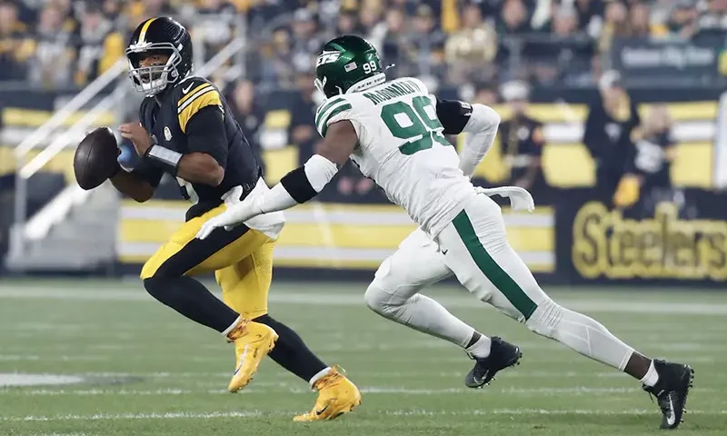 Pittsburgh Steelers quarterback Russell Wilson (3) scrambles against pressure from New York Jets defensive end Will McDonald IV (99) during the first quarter at Acrisure Stadium. Mandatory Credit: Charles LeClaire-Imagn Images