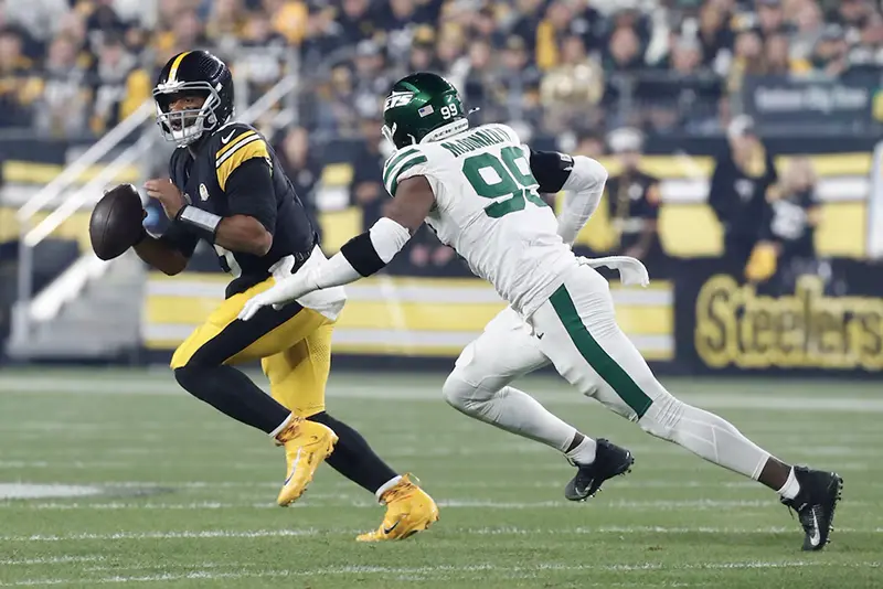 Pittsburgh Steelers quarterback Russell Wilson (3) scrambles against pressure from New York Jets defensive end Will McDonald IV (99) during the first quarter at Acrisure Stadium. Mandatory Credit: Charles LeClaire-Imagn Images