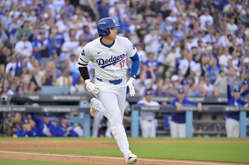 Los Angeles Dodgers designated hitter Shohei Ohtani (17) runs to first after hitting a single in the first inning against the New York Mets during game six of the NLCS for the 2024 MLB playoffs at Dodger Stadium. Mandatory Credit: Jayne Kamin-Oncea-Imagn Images