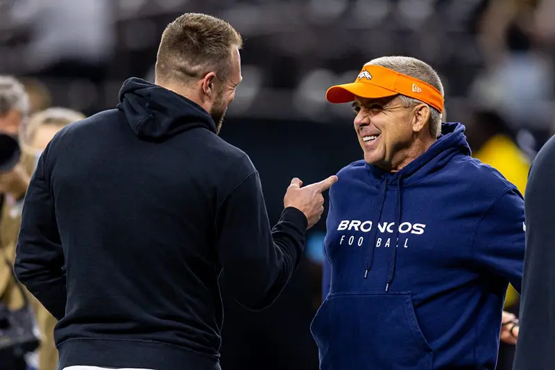 Denver Broncos head coach Sean Payton talks with New Orleans Saints tight end Taysom Hill (7) during the warmups before the game against the Denver Broncos at Caesars Superdome. Mandatory Credit: Stephen Lew-Imagn Images