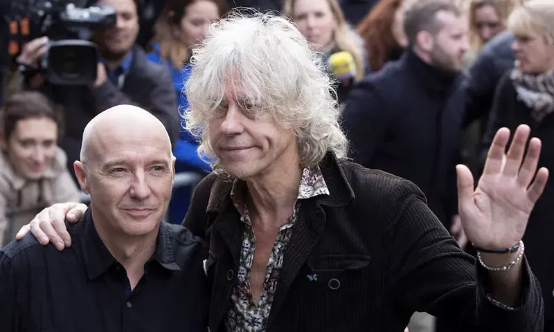 Musician's Midge Ure (L) and Bob Geldof pose as they attend the recording of the Band Aid 30 charity single in west London November 15, 2014. REUTERS/Neil Hall/File Photo
