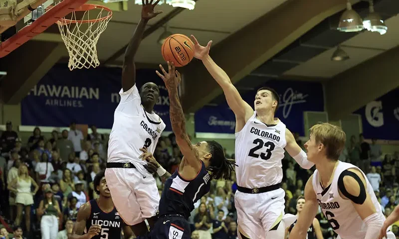 Connecticut Huskies guard Solo Ball (1) makes a layup in between Colorado Buffaloes forward Bangot Dak (8) and forward Andrej Jakimovski (23) during the second half of an NCAA college basketball game at Lahaina Civic Center. Mandatory Credit: Marco Garcia-Imagn Images/File Photo