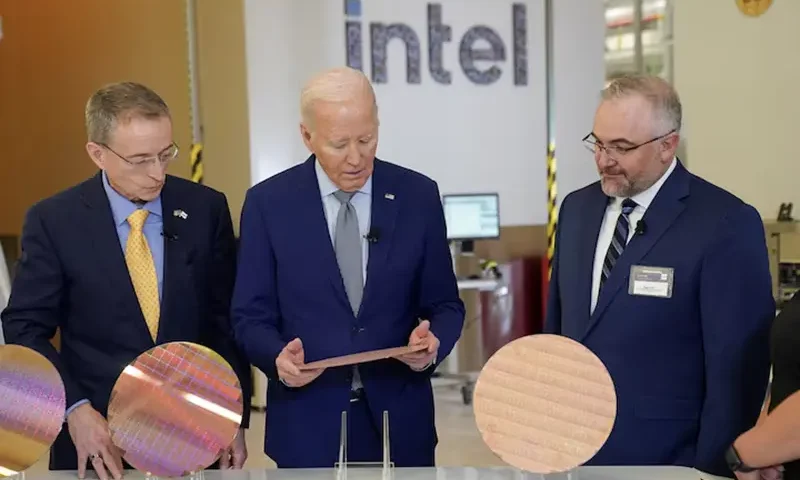 U.S. President Joe Biden looks at a wafer, as he tours the Intel Ocotillo Campus, in Chandler, Arizona, U.S., March 20, 2024. REUTERS/Kevin Lamarque/File Photo