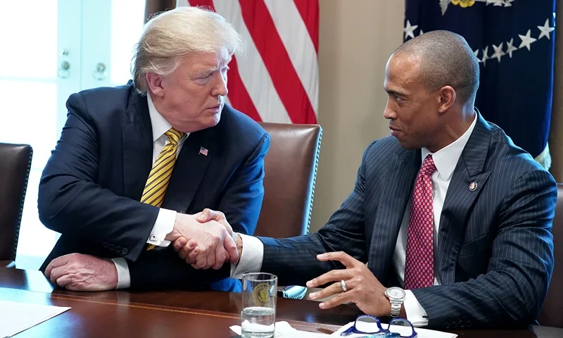 President Donald Trump makes shakes hands with White House Opportunity and Revitalization Council Executive Director Scott Turner during the inaugural meeting of the council in the Cabinet Room at the White House April 04, 2019 in Washington, DC. The council was formed to carry out the Trump administration’s plan "to encourage public and private investment in urban and economically distressed areas, including qualified opportunity zones," according to the White House. (Photo by Chip Somodevilla/Getty Images)