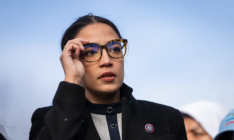 WASHINGTON, DC - DECEMBER 7: Rep. Alexandria Ocasio-Cortez (D-NY) prepares to speak during a rally for immigration provisions to be included in the Build Back Better Act outside the U.S. Capitol December 7, 2021 in Washington, DC. Progressive Democrats are urging the Senate to include a pathway to citizenship for undocumented immigrants living in the U.S. in the Build Back Better Act. (Photo by Drew Angerer/Getty Images)