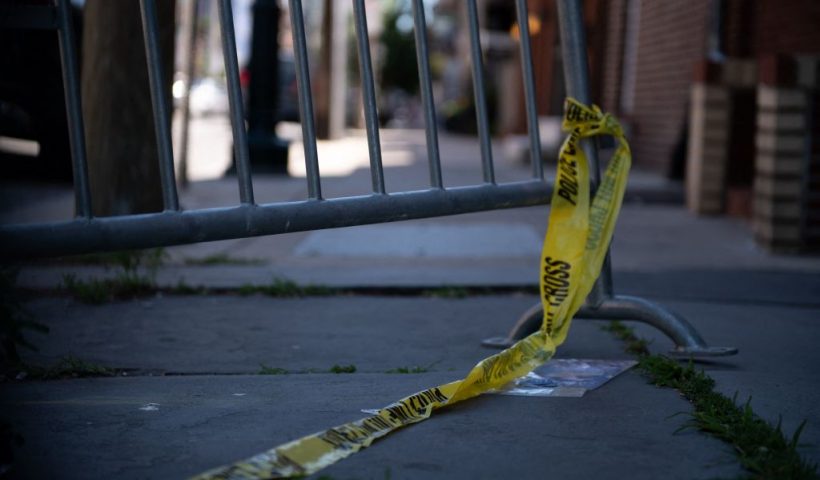 Police tape hangs from a barricade at the corner of Lombard and 4th Streets in Philadelphia, Pennsylvania, on June 5, 2022, the day after gunfire left three people dead and 11 others wounded. - Three people were killed and 11 others wounded late on June 4, 2022, in the US city of Philadelphia after multiple shooters opened fire into a crowd on a busy street, police said. (Photo by Kriston Jae Bethel / AFP) (Photo by KRISTON JAE BETHEL/AFP via Getty Images)