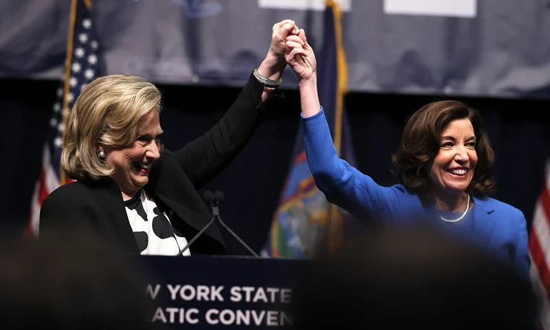 NEW YORK, NEW YORK - FEBRUARY 17:Former Secretary of State Hillary Clinton raises the hand of New York Gov. Kathy Hochul during the 2022 New York State Democratic Convention at the Sheraton New York Times Square Hotel on February 17, 2022 in New York City. Former Secretary of State Hillary Clinton gave the keynote address during the second day of the NYS Democratic Convention where the party organized the party's platform and nominated candidates for statewide offices that will be on the ballot this year including the nomination of Gov. Kathy Hochul and her Lt. Gov. Brian Benjamin. (Photo by Michael M. Santiago/Getty Images)