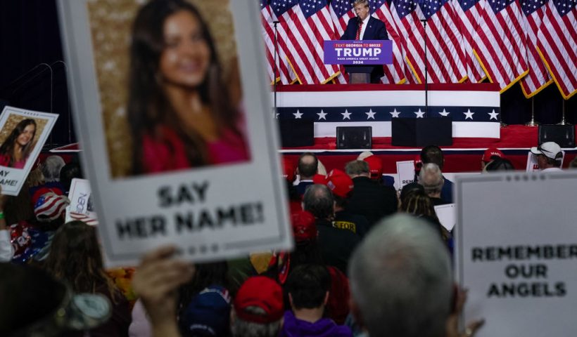 Former US President and 2024 presidential hopeful Donald Trump speaks as supporters hold images of Laken Riley during a campaign event in Rome, Georgia, on March 9, 2024. Riley, a nursing student, has become the face of immigration reform after her murder allegedly by an illegal immigrant on February 22, 2024. (Photo by Elijah Nouvelage / AFP) (Photo by ELIJAH NOUVELAGE/AFP via Getty Images)