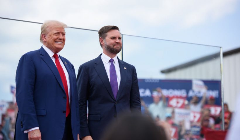 ASHEBORO, NORTH CAROLINA - AUGUST 21: Republican Presidential candidate, former U.S. president, Donald Trump, left, poses for photos with Republican Vice Presidential candidate, U.S. Sen. J.D. Vance, (R-OH), before making remarks to a crowd during an event on August 21, 2024 in Asheboro, North Carolina at the North Carolina Aviation Museum and Hall of Fame. Mr. Trump and Vice Presidential hopeful JD Vance stood behind a thick plate glass as added security measures were visible around the event. (Photo by Melissa Sue Gerrits/Getty Images)