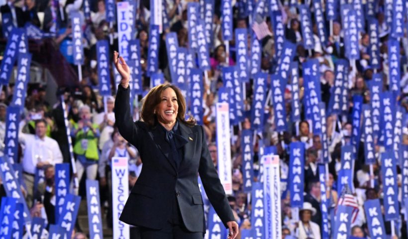 TOPSHOT - US Vice President and 2024 Democratic presidential candidate Kamala Harris waves as she arrives to speak on the fourth and last day of the Democratic National Convention (DNC) at the United Center in Chicago, Illinois, on August 22, 2024. Vice President Kamala Harris formally accepted the party's nomination for president today at the DNC which ran from August 19-22 in Chicago. (Photo by Robyn Beck / AFP) (Photo by ROBYN BECK/AFP via Getty Images)