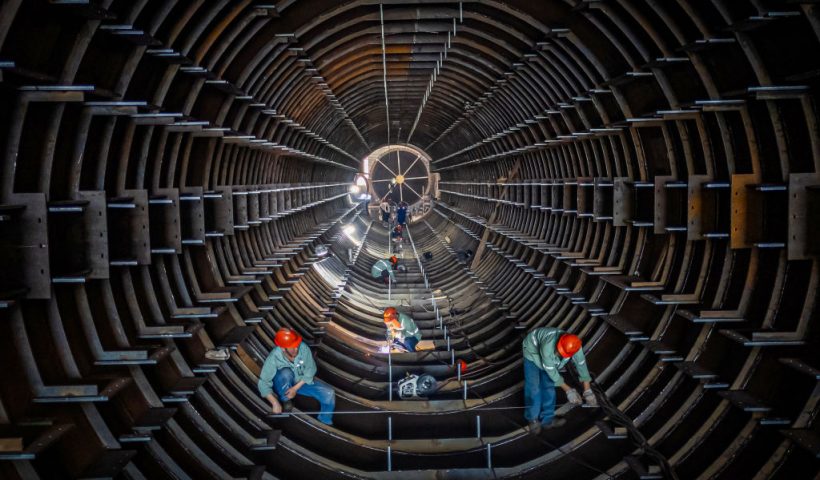 TOPSHOT - Employees work on a steel tube tower production line at a factory in Haian, in eastern China's Jiangsu province on September 1, 2024. (Photo by AFP) / China OUT (Photo by STR/AFP via Getty Images)