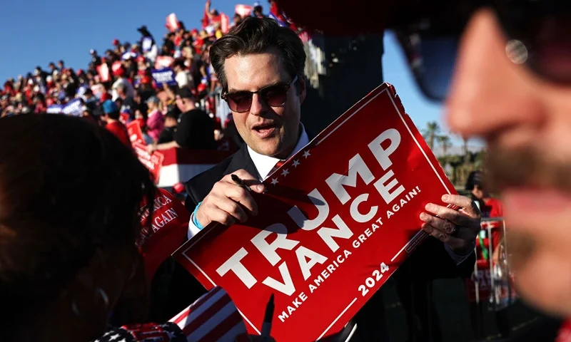 COACHELLA, CALIFORNIA - OCTOBER 12: U.S. Rep. Matt Gaetz (R-FL), C, prepares to sign a Trump-Vance sign at a campaign rally for Republican presidential nominee, former U.S. President Donald Trump on October 12, 2024 in Coachella, California. With 24 days to go until election day, former President Donald Trump is detouring from swing states to hold the rally in Democratic presidential nominee, Vice President Kamala Harris' home state. (Photo by Mario Tama/Getty Images)