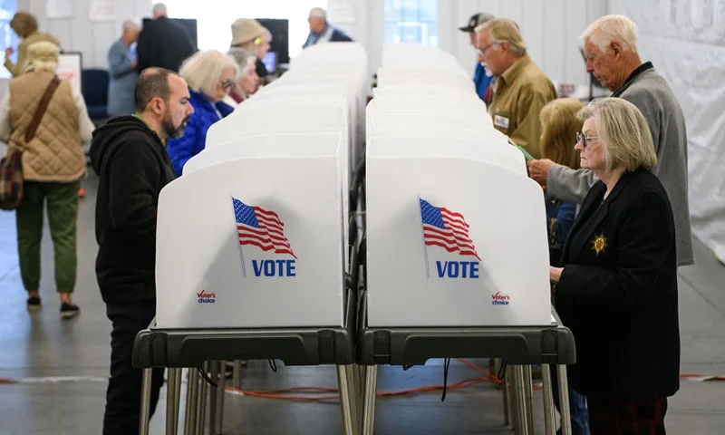 HENDERSONVILLE, NORTH CAROLINA - OCTOBER 17: Voters make selections at their voting booths inside an early voting site on October 17, 2024 in Hendersonville, North Carolina. Several counties effected by Hurricane Helene saw a large turnout of residents for the first day of early voting in Western North Carolina. (Photo by Melissa Sue Gerrits/Getty Images)