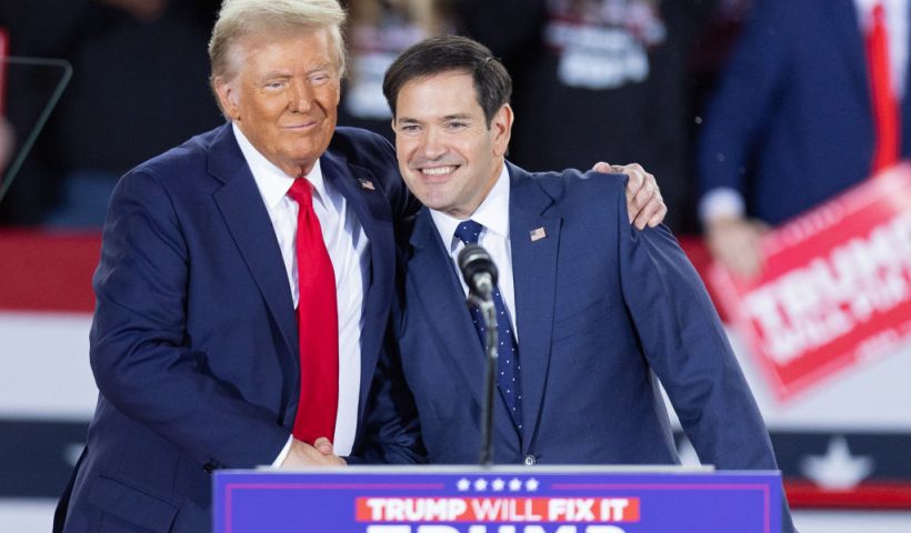Former US President and Republican presidential candidate Donald Trump greets Senator Marco Rubio, Republican of Florida, during a campaign rally at the J.S. Dorton Arena in Raleigh, North Carolina, on November 4, 2024. Bitter rivals Kamala Harris and Donald Trump embark on a final frenzied campaign blitz Monday with both hitting must-win Pennsylvania on the last day of a tight and volatile US presidential election campaign. (Photo by Ryan M. Kelly / AFP) (Photo by RYAN M. KELLY/AFP via Getty Images)