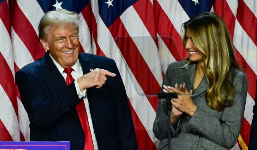 TOPSHOT - Former US President and Republican presidential candidate Donald Trump points to his wife former US First Lady Melania Trump during an election night event at the West Palm Beach Convention Center in West Palm Beach, Florida, early on November 6, 2024. (Photo by Jim WATSON / AFP) (Photo by JIM WATSON/AFP via Getty Images)