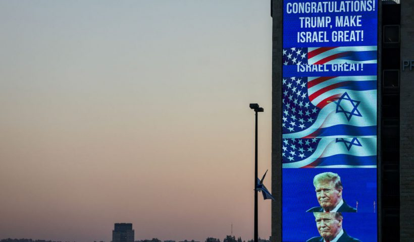 A large billboard congratulating US Republican presidential candidate and former president Donald Trump, is lit on the side of a building in Jerusalem on November 6, 2024. Israel's Prime Minister Benjamin Netanyahu on November 6 congratulated Donald Trump, who has won the US presidential election, calling it "history's greatest comeback" and a new beginning in the US-Israel alliance. (Photo by AHMAD GHARABLI / AFP) (Photo by AHMAD GHARABLI/AFP via Getty Images)
