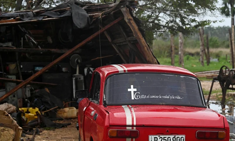 A car is pictured next to the debris of a house after the passage of hurricane Rafael in Batabano, Artemisa province, Cuba on November 7, 2024. Power was restored to parts of Cuba on Thursday a day after Hurricane Rafael swept over the island, leaving its 10 million inhabitants without electricity for the second time in a month. (Photo by YAMIL LAGE / AFP) (Photo by YAMIL LAGE/AFP via Getty Images)